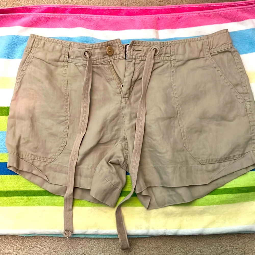 Tan linen Juicy Couture zip up and tie shorts with pockets.